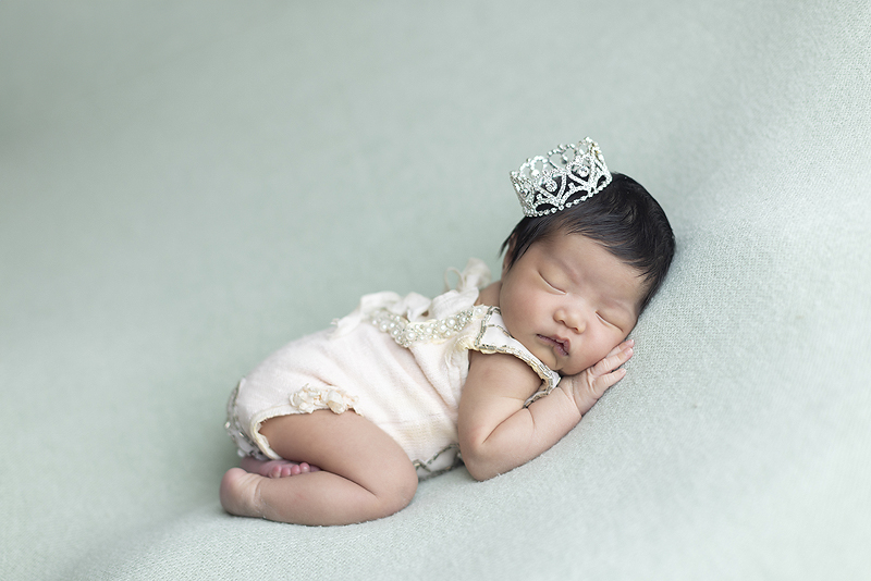 Newborn girl wearing crown