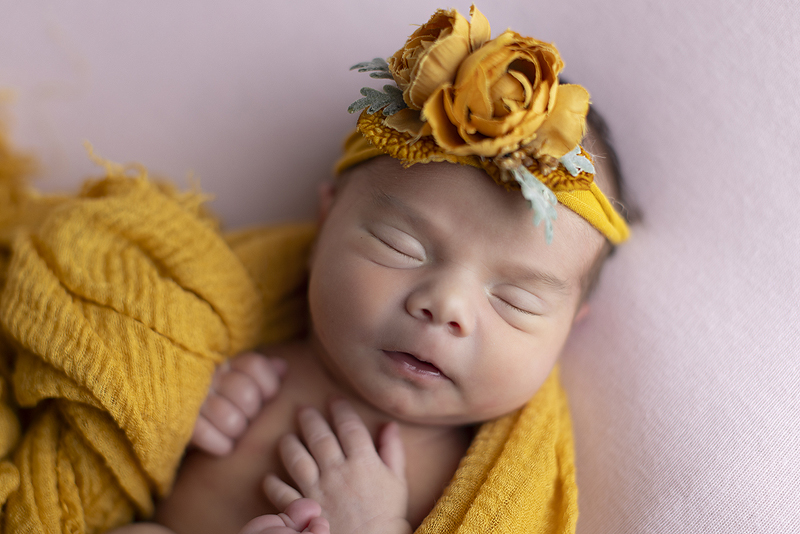 Newborn girl wearing yellow