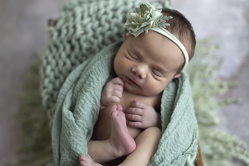 Newborns sleeps on mint colors