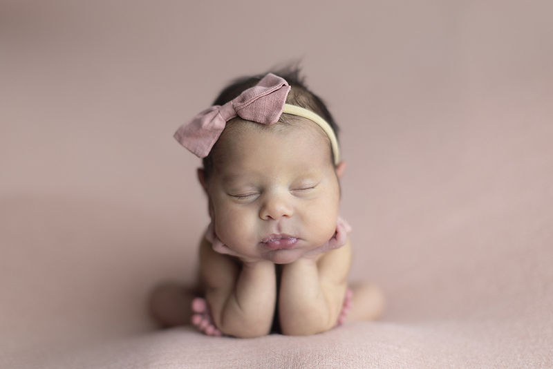 Newborn girl in froggie pose