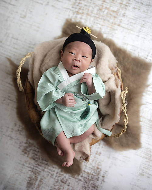 Newborn boy in cultural clothing